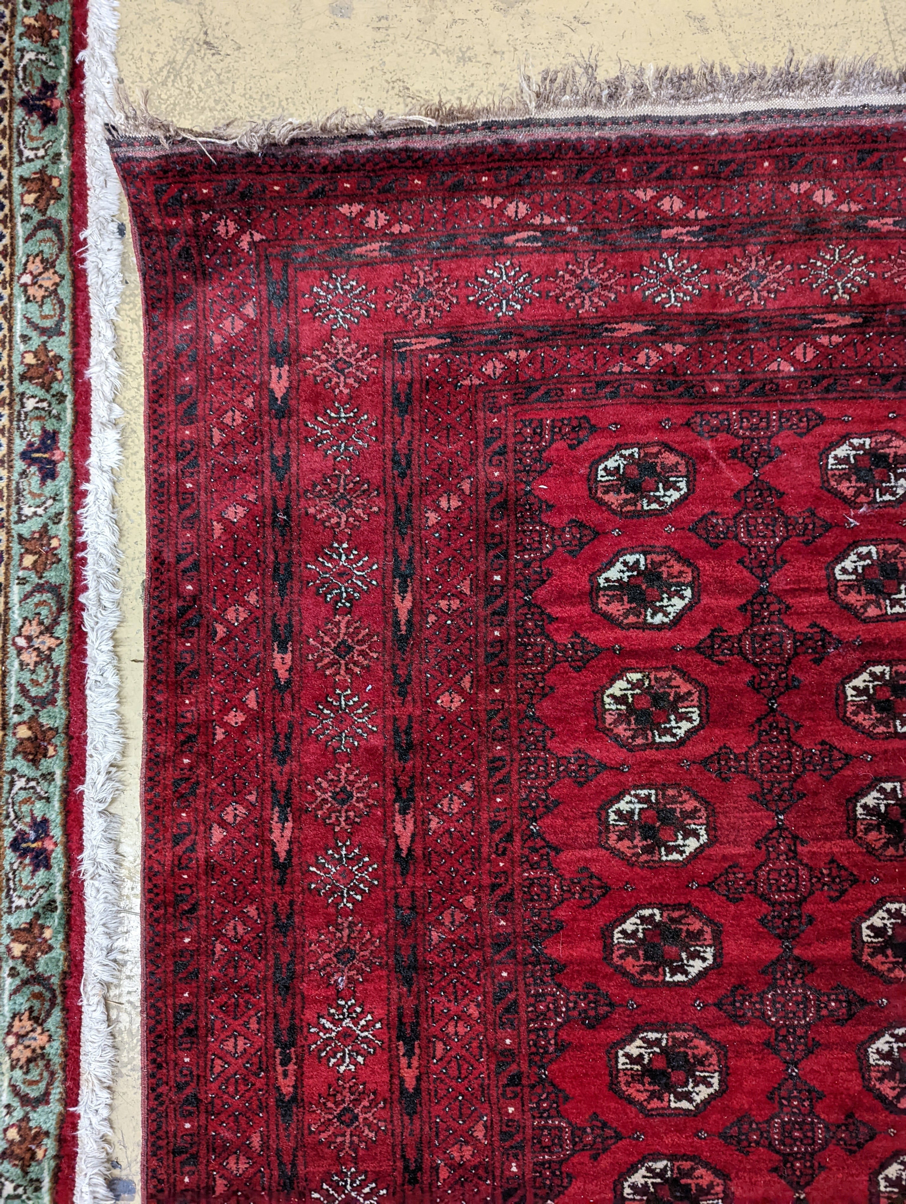 A Bokhara burgundy ground rug, 190 x 130cm